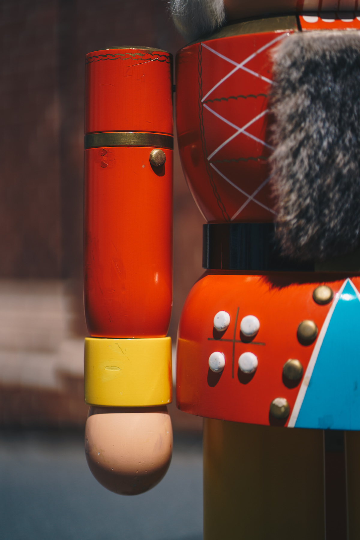 In the picture you can see a close-up of an ore birgish red nutcracker. It can be seen his right arm as well as his beard of fur and decorating buttons.